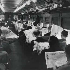 A crowded train in the 1950s, everyone is reading a newspaper and not talking to eachother.